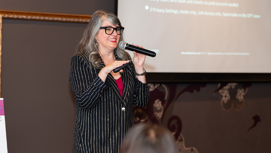 Molly Mahoney speaking to attendees at a live event